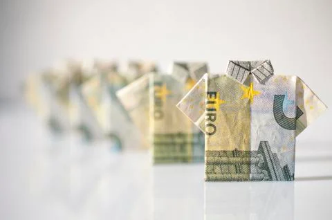 Finance concept: a row of men made with 5 euro bills folded like a t-shirt Stock Photos