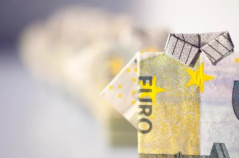 Finance concept: a row of men made with 5 euro bills folded like a t-shirt Stock Photos