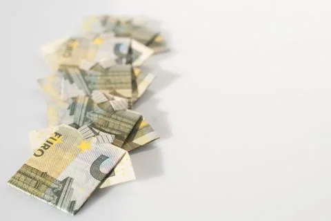 Finance concept: a row of men made with 5 euro bills folded like a t-shirt Stock Photos