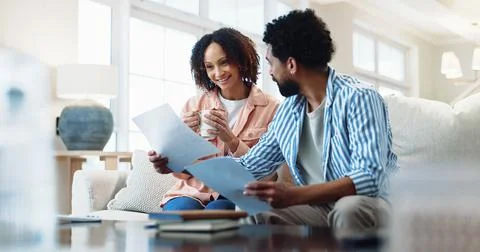 Finance, documents and happy couple with expenses in home for budget success or Stock-Fotos