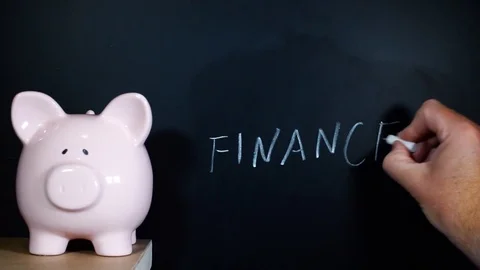 Finance handwritten on a chalkboard by a man Stock Footage 81930097