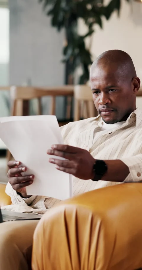 Finance, home or black man with documents on sofa for budget planning, expenses Stock Footage 336841876