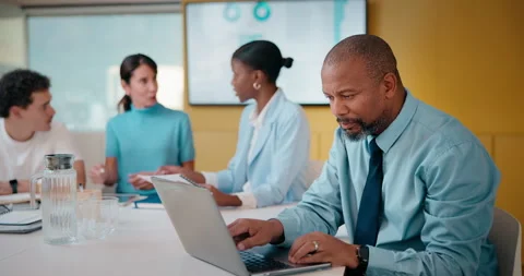 Finance, laptop and reading with man in meeting for review of data charts or Stock Footage 335452392