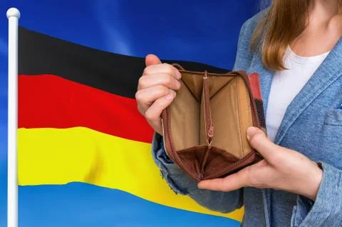 Finance problem in Germany. Poor person with empty wallet on national flag ba 스톡 사진