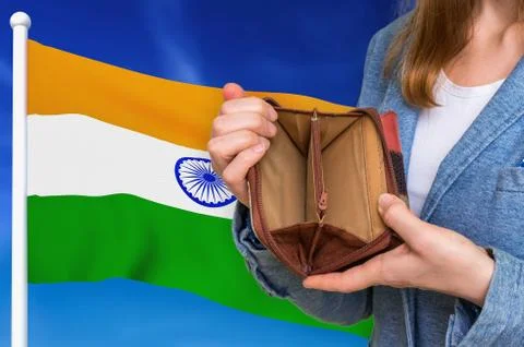 Finance problem in India. Poor person with empty wallet on national flag back Stock Photos