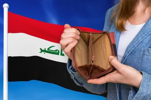 Finance problem in Iraq. Poor person with empty wallet on national flag backg Foto stock