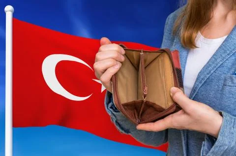 Finance problem in Turkey. Poor person with empty wallet on national flag bac 写真素材