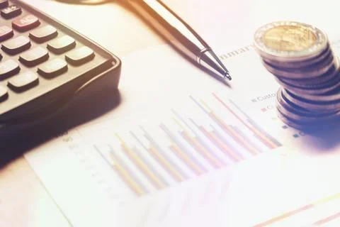 Finance saving concept, calculator with cion on paperwork report. Stock Photos
