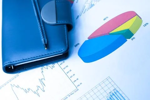 Finance Statistical graphs and notebook Stock Photos