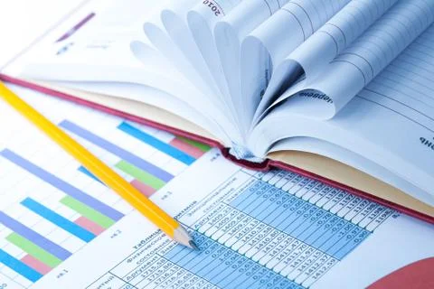 Finance Statistical graphs and notebook Stock Photos