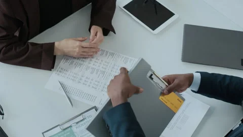 Financial Advisor and Client Finalizing Loan Agreement with Handshake 動画素材 300430852