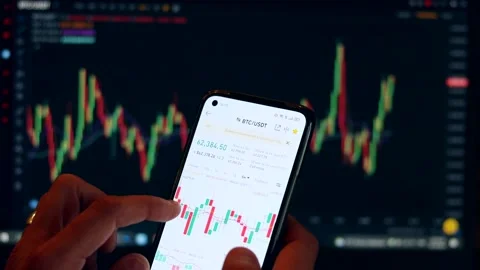 Financial analysis using mobile app and laptop, risk analysis of stockbrokers Stock Footage 164562161