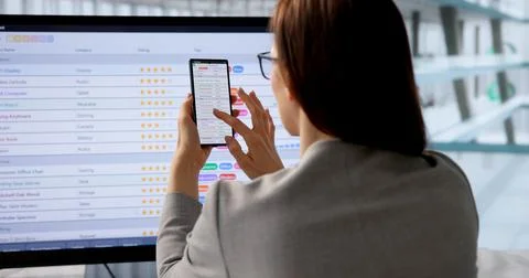 Financial Analyst Analyzing Spreadsheet Data On Computer And Smartphone In Mo 스톡 사진