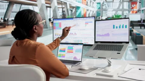 Financial Analyst Carefully Examines Data On Laptop Stockbeeldmateriaal 337644794