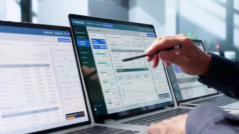 Financial Analyst Carefully Reviews Cloud Spending Reports Stock Footage 345320764