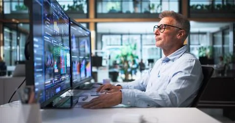 Financial Analyst Carefully Studying Data Dashboard To Predict Market Trends. Stock Photos