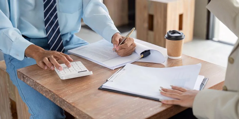 Financial Analyst Conducting Precise Data Entry and Analysis in a Cozy Cafe Stock Photos