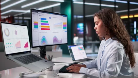 Financial Analyst Examining Data Dashboard On Laptop Stockbeeldmateriaal 336796418