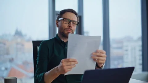 Financial analyst reading documents at office workplace by window closeup. Stock Footage 340296282