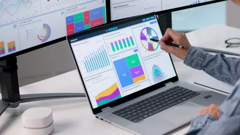 Financial Analyst Reviewing Dashboard Data Carefully On Laptop Stockbeeldmateriaal 336794193