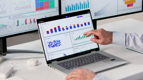 Financial Analyst Reviewing Data Charts On Laptop For Market Insights Stock Footage 334537974