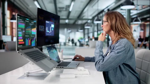Financial Analyst Reviewing Data Dashboard On Laptop Stockbeeldmateriaal 336793791