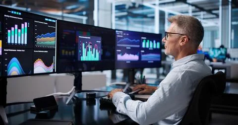 Financial Analyst Reviews Dashboard Data, Pointing To Market Trends Confident Stock Photos