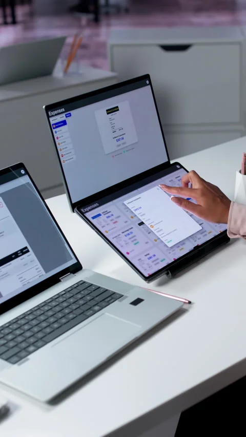 Financial Analyst Reviews Expense Reports Carefully Using Laptop Stock Footage 336797223