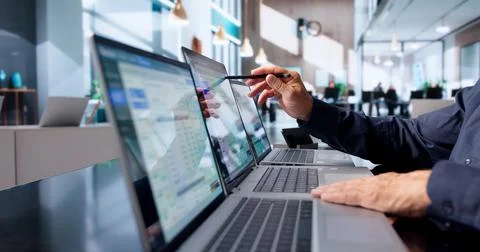 Financial Analyst Studies Cloud Cost Data On Laptop To Optimize Budget. Stock Photos