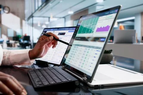 Financial Analyst Studies Cloud Spend Data On Laptop For Budget Optimization. Stock Photos