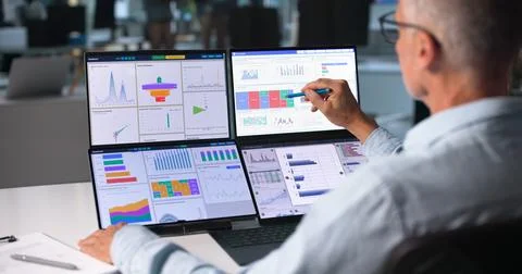 Financial Analyst Studies Predictive Data Charts Closely, Making Smart Invest Stock Photos