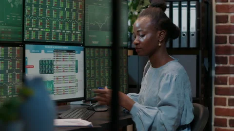 Financial analyst taking notes on clipboard to work on stock trade Stock Footage 170780481