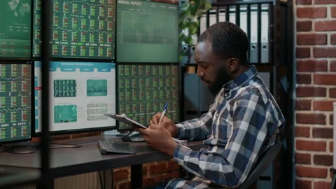Financial analyst taking notes on clipboard about stock market sales Stock Footage 170784479