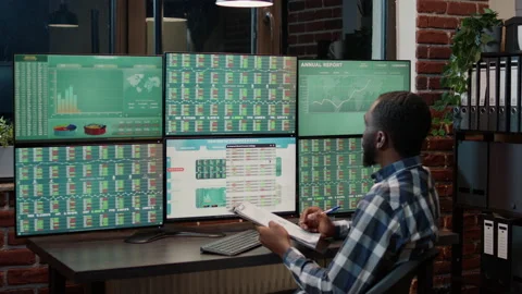 Financial analyst taking notes on clipboard to plan trade market sales Stock Footage 170785503