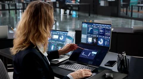 Financial Analyst Using Computer To Manage Business Data In Office Stock Photos