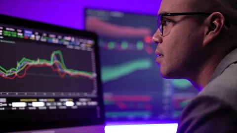 Financial analyst working with exchange rate diagram in neon light. Investor. Stock Footage 185344071