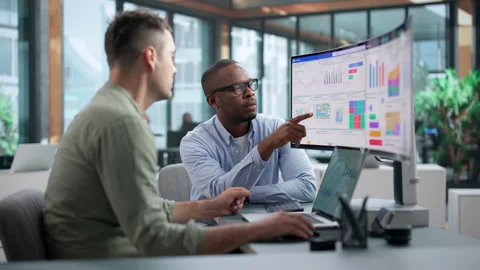 Financial Analysts Discuss Data Trends Stock Footage 345312316