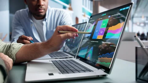Financial Analysts Discussing Predictive Data On Dashboard Stock Footage 345312431