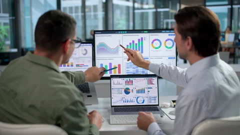Financial Analysts Review Data Dashboards Closely Stock Footage 347903115