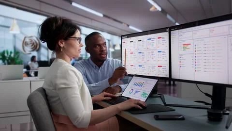 Financial Analysts Reviewing Expense Reports Together Stock Footage 341003962
