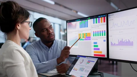 Financial Analysts Reviewing Key Performance Dashboard On Laptop Stock Footage 343882740