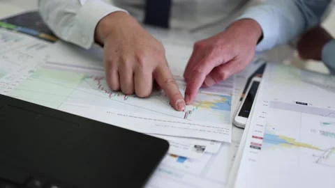 Financial and securities managers exchange and analyze the financial stateme Stock Footage 168115740