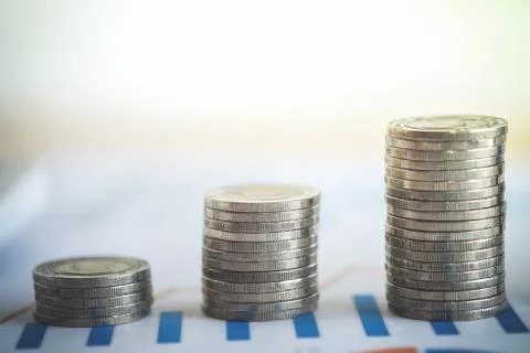 Financial banking stock spreadsheet with stack of coin and background on acco Stock Photos