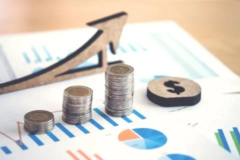 Financial banking stock spreadsheet with stack of coin and background on ac.. Stock Photos