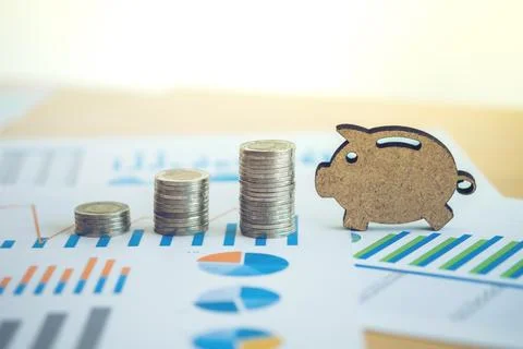 Financial banking stock spreadsheet with stack coin and piggy on accountant.. Stock Photos