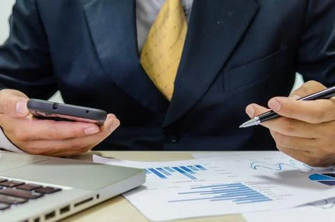Financial business man document graph analyzing Stock Photos