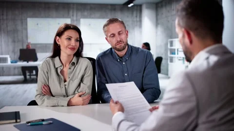 Financial Consultant Explaining New Project Investment To Young Couple Video stock 292209183