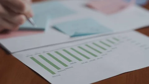 Financial data and reports, hand with a pen on a background. Stock Footage 129267230