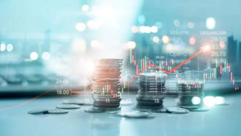 Financial data on a city background. Stack of coins with stock market graph.. Stock Photos