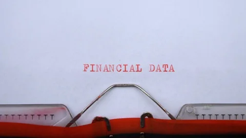 Financial data - phrase printed on an old typewriter in red letters, close up. Stock Footage 129535646